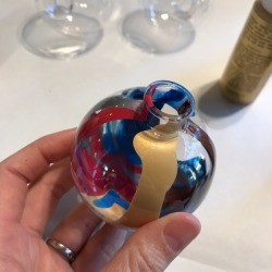 Poured Paint Ornaments - several colors of paint dripped down the inside of the ornament