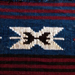 A South American woven rug with bright colors.