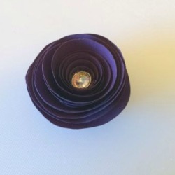 A small flower made from a spiral of paper.