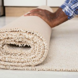 A roll of carpet with a raw edge.