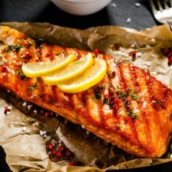 Cajun Fried Salmon topped with lemon slices.