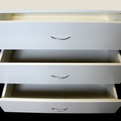 White Press board dresser with 3 drawers open.