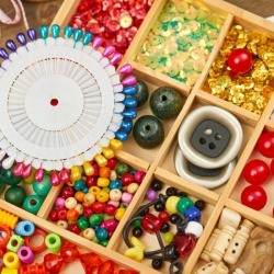 Beads and Buttons sorted in a wooden compartments