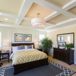 Master bedroom with a yellow and grey color scheme.