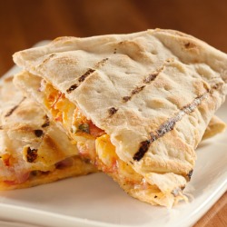 Chicken Quesadillas on a white plate and wooden table