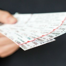 Man holding tickets to sports game