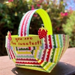 Craft Paper Basket - basket sitting outside on deck railing