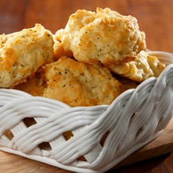 Garlic cheese biscuits in a white ceramic basket.