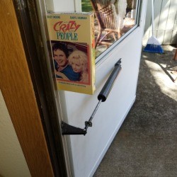 A VHS tape being used to prop a door open.