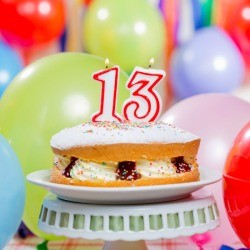 Naked cake with the number 13 candle on top.