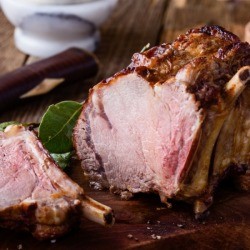 Prime Rib Roast with bone-in on wooden cutting board