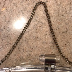 A tarnished chain that has been cleaned on the left hand side.