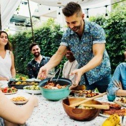 Friends at table with potluck food