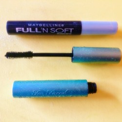 An expensive mascara wand next to a cheap mascara.