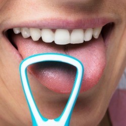 Man cleaning his tongue with tongue cleaner