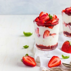Strawberry and cream dessert in a glass.