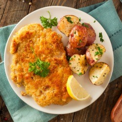 Vienna Potatoes on white plate on top of a wooden table