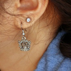 Silver earring in a woman's ear