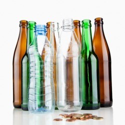 Glass and plastic bottles with change in front of them