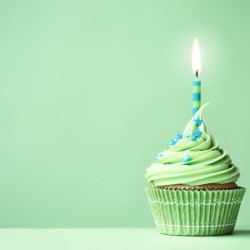 Green cupcake with a blue and green candle.