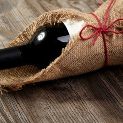 Bottle of wine wrapped in burlap.