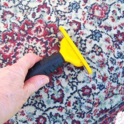 Comb Your Rugs Clean - using a pet comb on a rug
