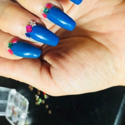 Small jewels attached where the manicure color has grown out.