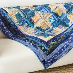 Blue quilt on a white sofa.