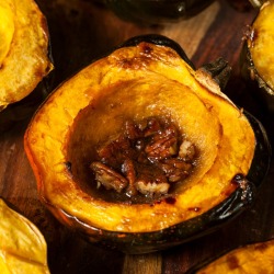 Baked acorn squash halves with pecans.