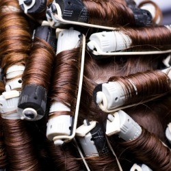 Hair in curlers getting a perm.