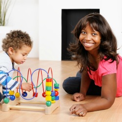 Woman and a toddler playing on the floor.