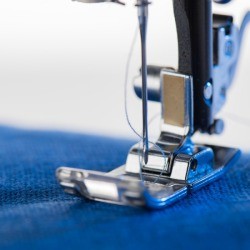 Closeup of sewing machine foot.