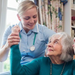 Nurse helping someone who suffered a stroke.