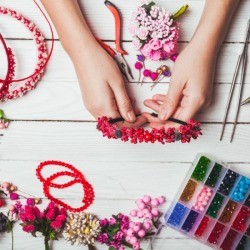 Craft table full of things to decorate headbands with beads.