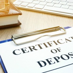 Certificates of Deposit on a desk.