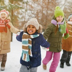 Kids happy playing in the snow.