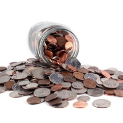 A jar of coins spilling out on a white background.