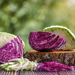 Cut Red and green cabbage on a table, outside.