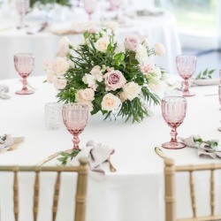 Wedding Reception table with a floral arrangement in the middle.