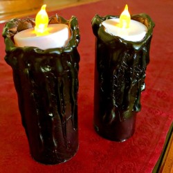 Spooky Candles - lit candles on red surface