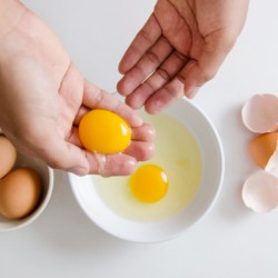 Separating egg yolks from the whites with your hands.