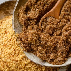 Soft brown dark sugar and unrefined sugar cane .