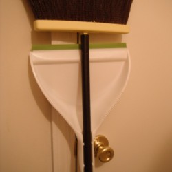 Adjusting a Dust Pan Clamp - broom and attached pan hanging 