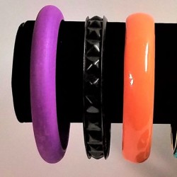 Bracelets on a stand with a white background.
