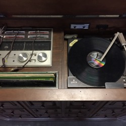 Turntable and controls for a vintage zenith console stereo system.