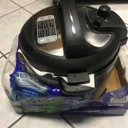 An InstantPot inside a recycled cardboard box.