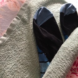 A pair of wet socks inside a towel.