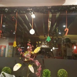 Sparkling Paper Ornaments - paper ornaments hanging from a mirror frame