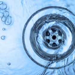 Water going down the sink drain.