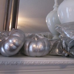 Transforming Gourds Into Elegant Decor - two gourds on a white mantle